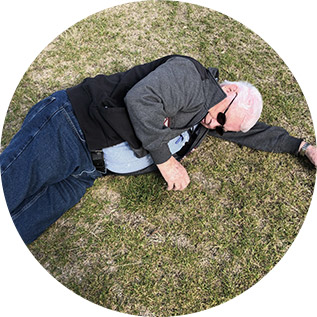 Elderly senior man using government funded personal alarm to call for help